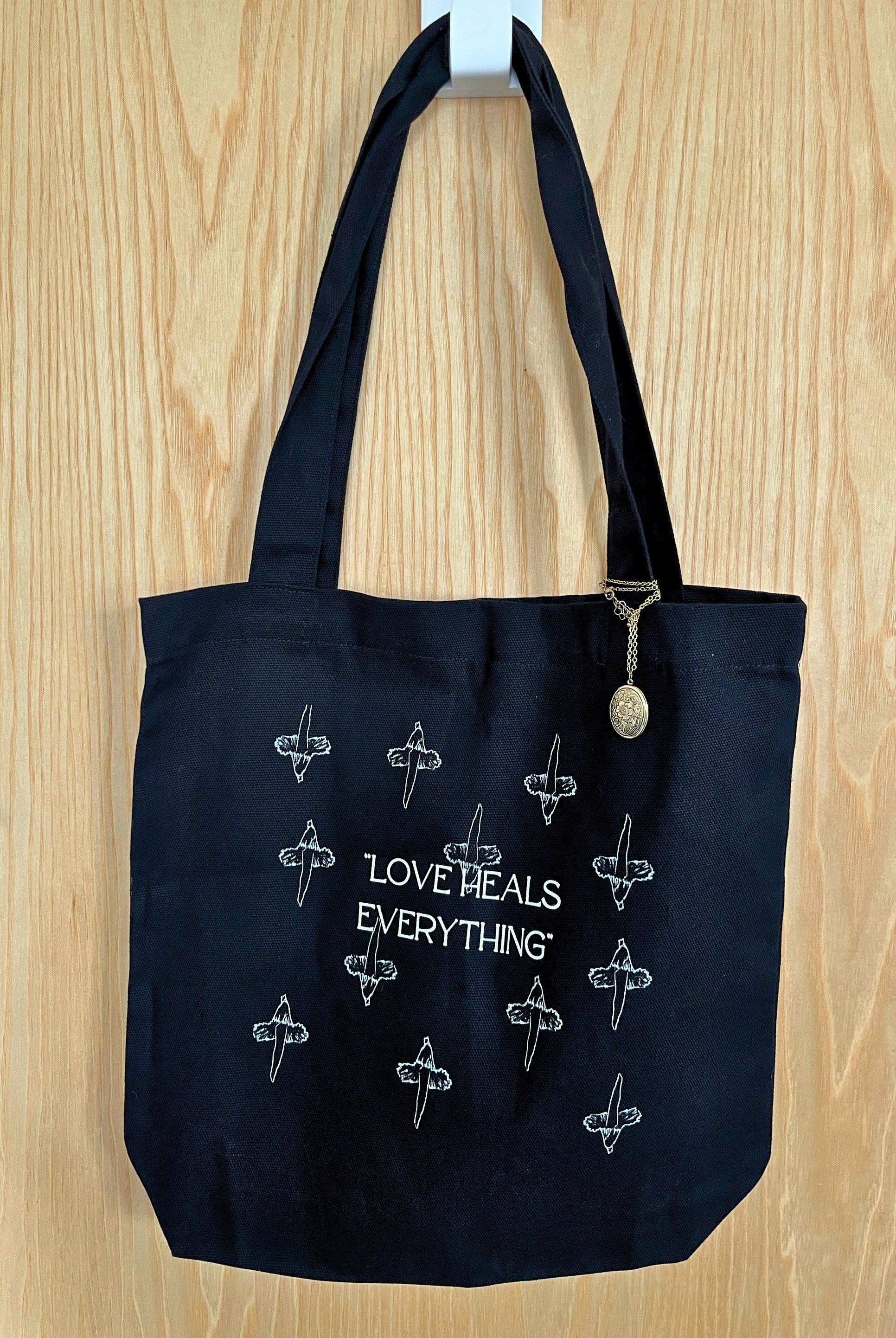 Tote bag with quote "love heals everything"