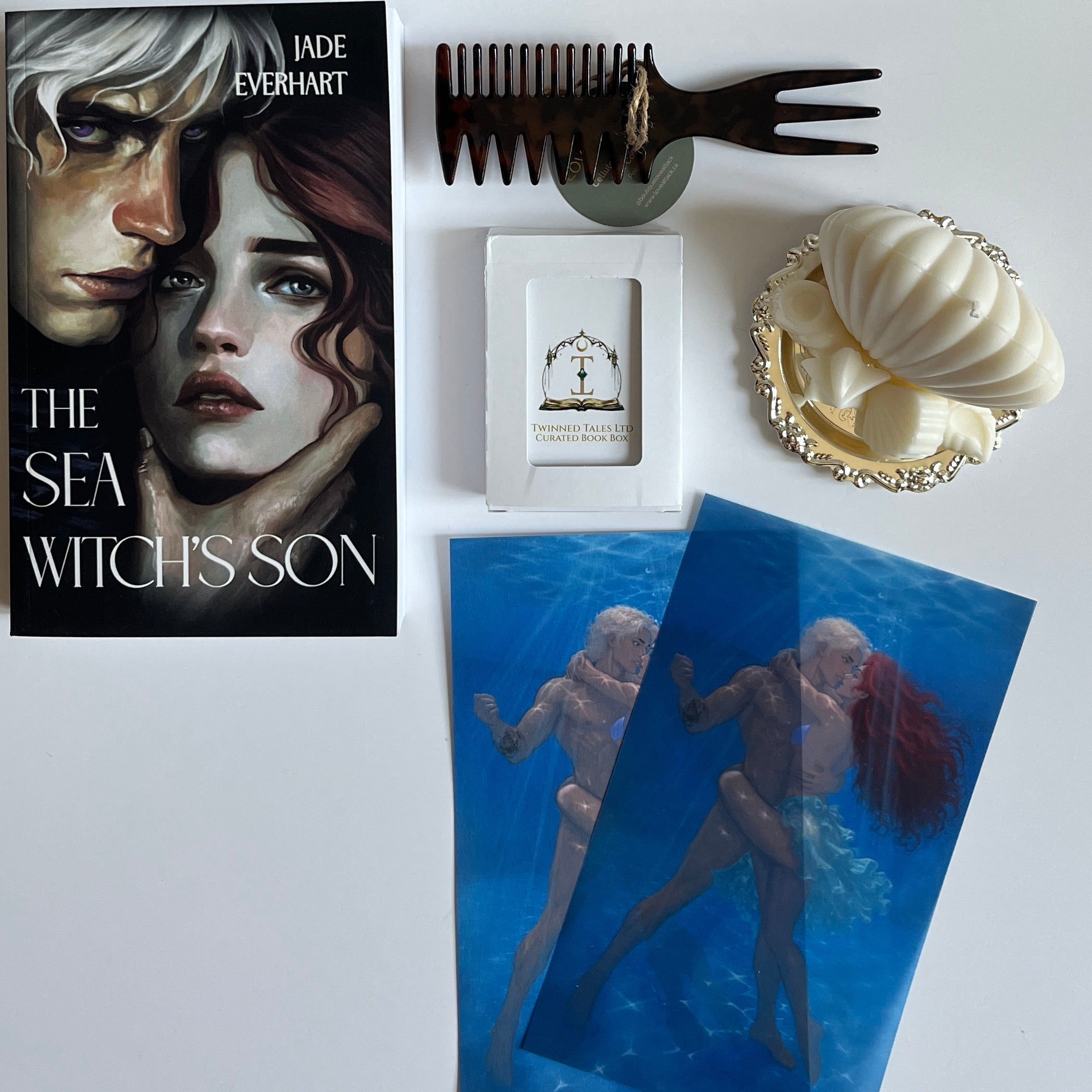 Book, playing cards, hair comb, character art, candles, trinket dish