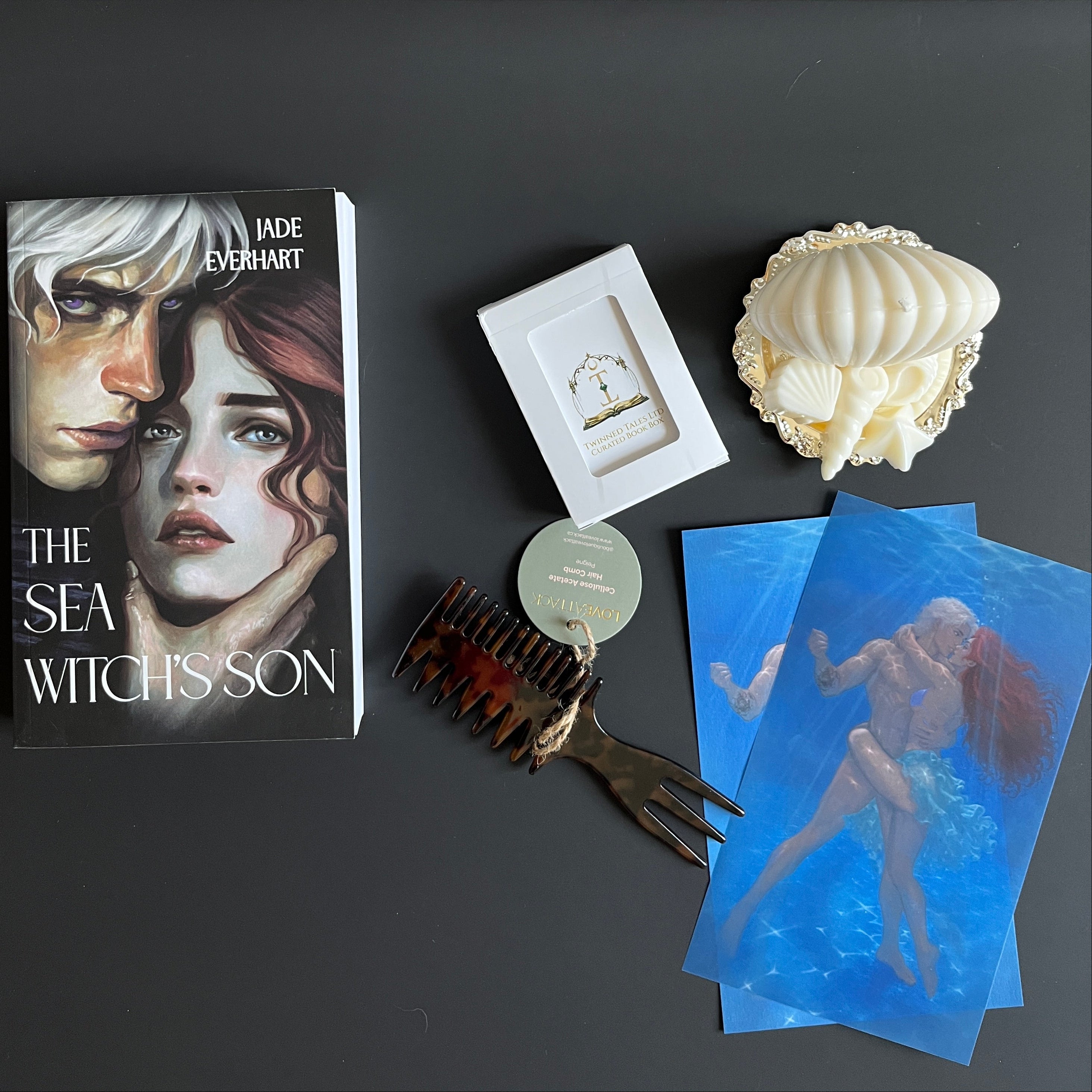 Book, playing cards, hair comb, character art, candles, trinket dish
